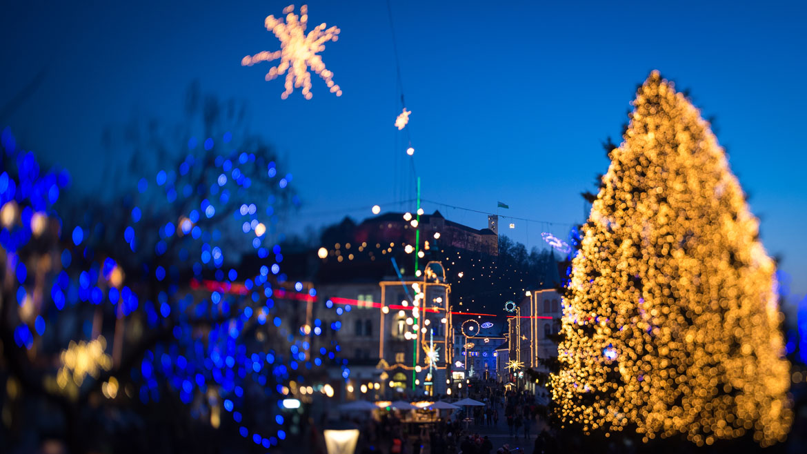 This picture taken with a tilt and shift lens shows people walking in the centre of Ljubljana as it is illuminated with Christmas decorations on December 6, 2013.   AFP PHOTO / JURE MAKOVEC